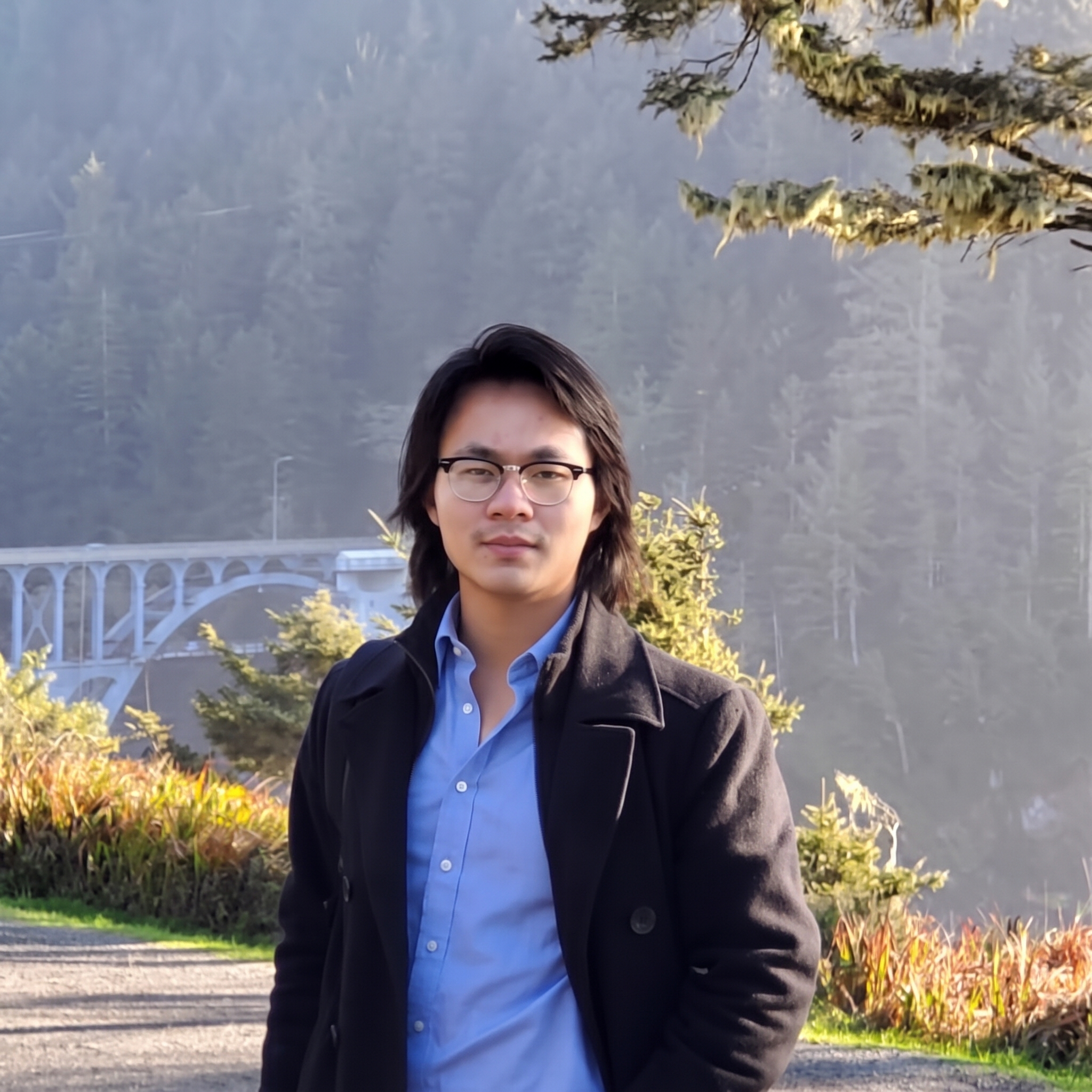 Alexandre Chen outdoors near a bridge